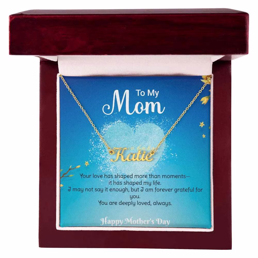 Close-up of engraved name pendant on personalized Mother’s Day necklace, meaningful gift for mom.